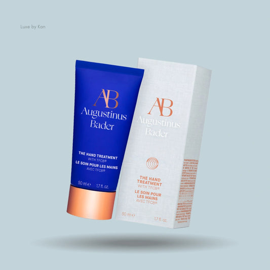 Augustinus Bader Hand Treatment featuring the product tube alongside its box packaging.