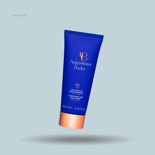 A blue tube of Augustinus Bader The Leave-In Hair Treatment, shown with its cap on.