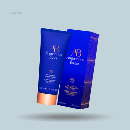 Augustinus Bader leave-in hair treatment tube and corresponding packaging in blue, with copper accents.