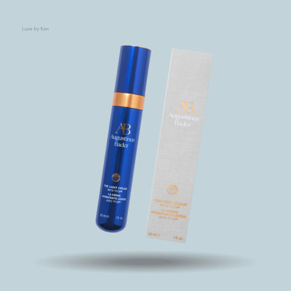 Augustinus Bader The Light Cream angled next to its packaging.