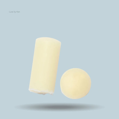 Close-up of Augustinus Bader The Lip Balm cylinder and ball.