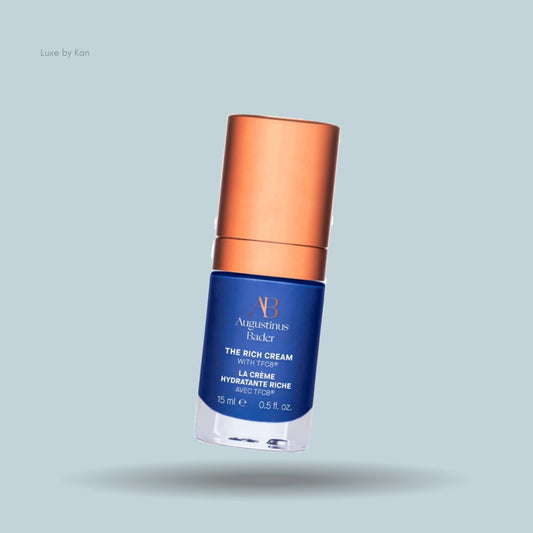 A luxurious blue jar of Augustinus Bader's "The Rich Cream" with a copper lid, showcasing its elegant design and anti-aging formula.