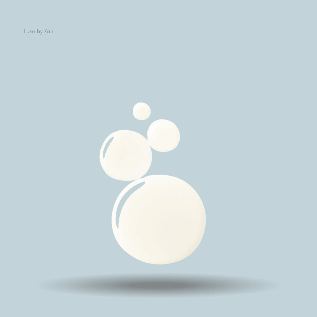 Creamy bubbles from the Augustinus Bader Scalp Treatment float above a soft shadow.