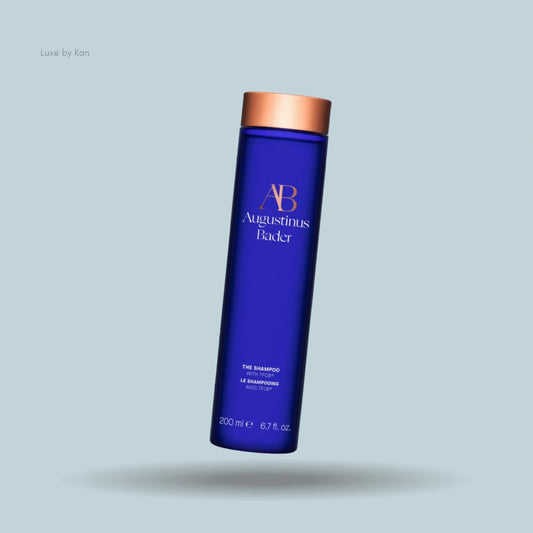 Blue Augustinus Bader shampoo bottle with copper cap.