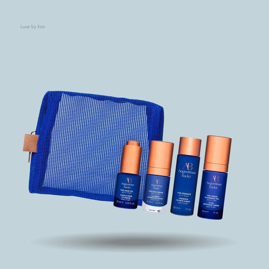 Augustinus Bader Starter Kit: Mesh bag and 4 blue/copper skincare bottles.