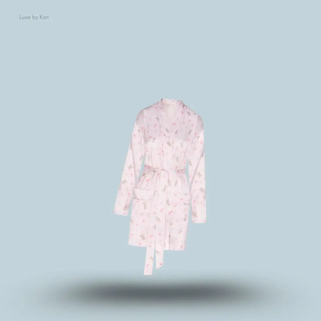 SKIMS Woven Shine Robe in Barely Pink Snack Bag, flat lay on light blue background