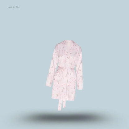SKIMS Woven Shine Robe in Barely Pink Snack Bag, flat lay on light blue background
