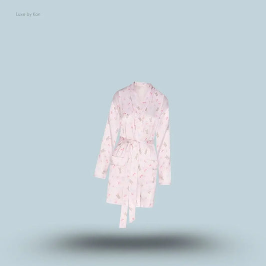 SKIMS Woven Shine Robe in Barely Pink Snack Bag, flat lay on light blue background