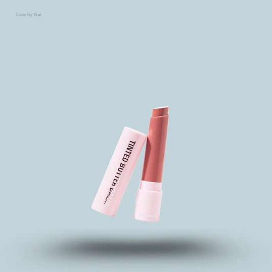 Kylie Cosmetics Tinted Butter Balm stick on blue background — Luxe by Kan India