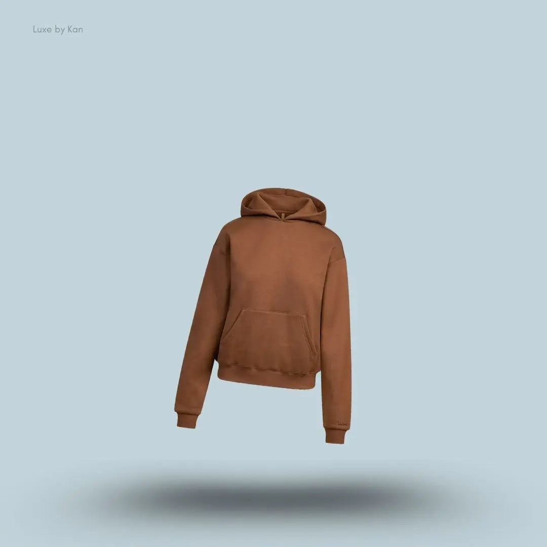 SKIMS Cotton Fleece Classic Hoodie in Bison, flat lay on light blue background