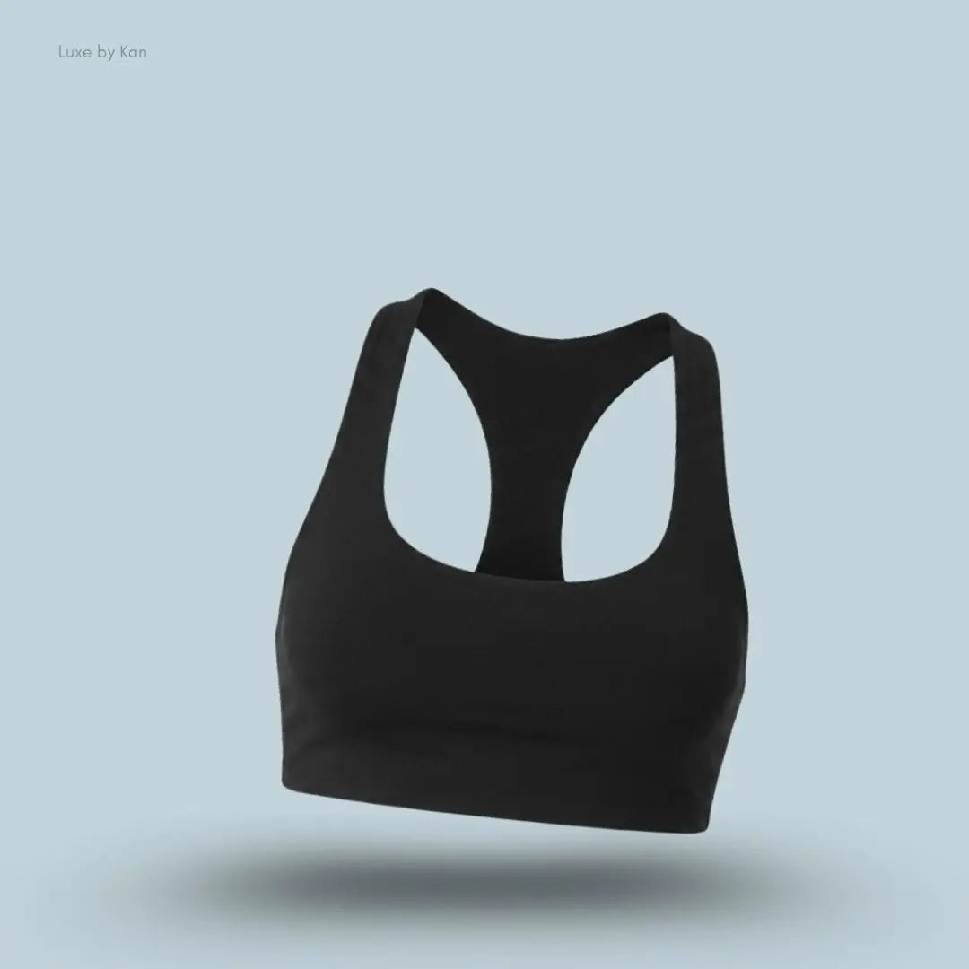 Alo Airlift Advantage Racerback Bra in Black, flat lay on light blue background