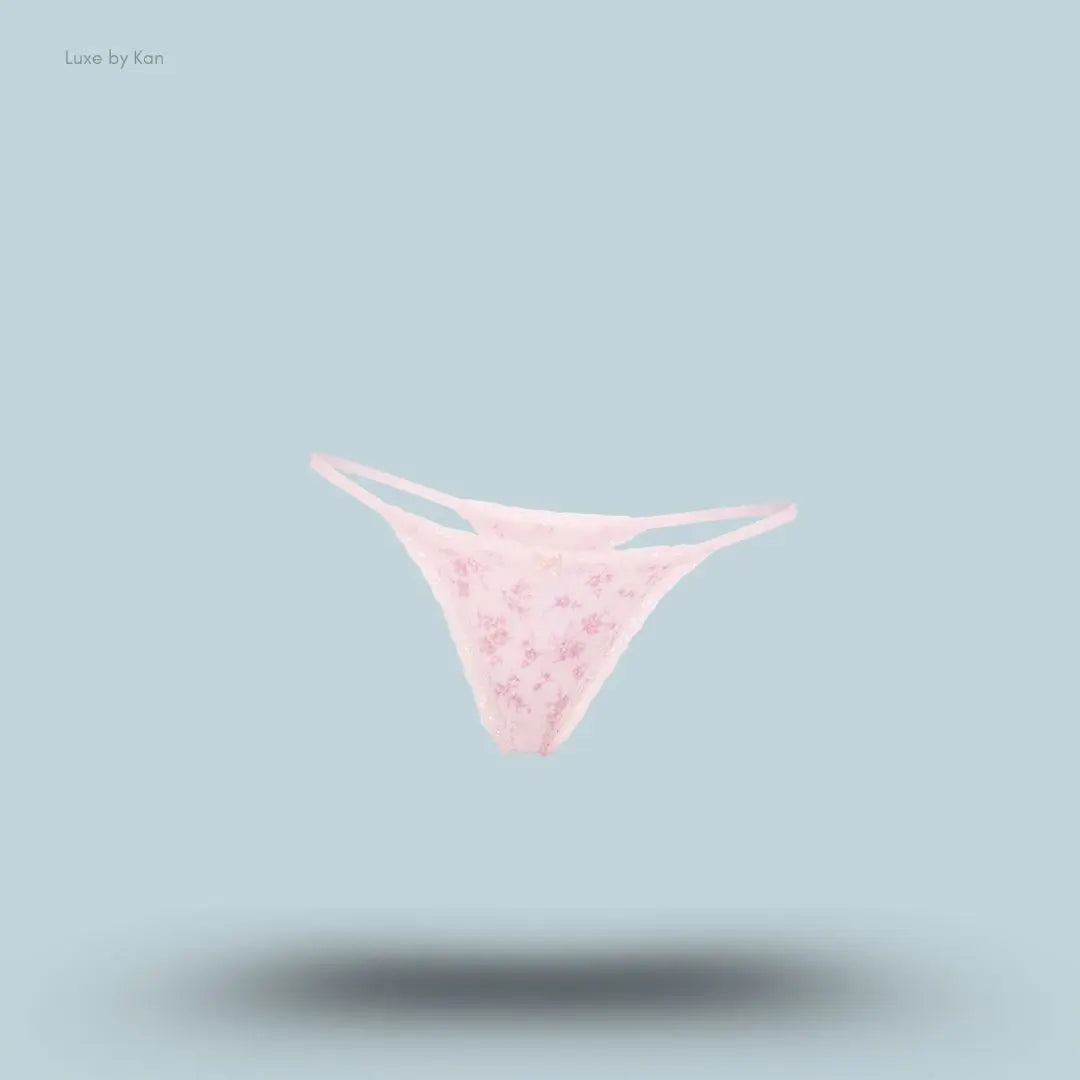 SKIMS Lightweight Cotton Pointelle Lace String Thong in Bloom Dainty Floral, flat lay on light blue background