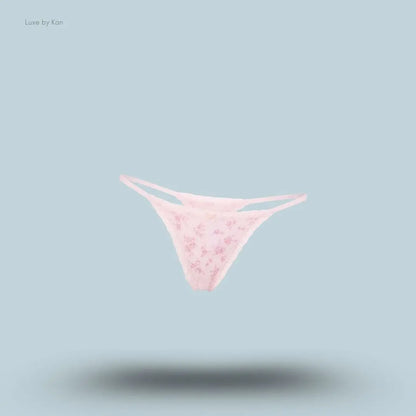 SKIMS Lightweight Cotton Pointelle Lace String Thong in Bloom Dainty Floral, flat lay on light blue background