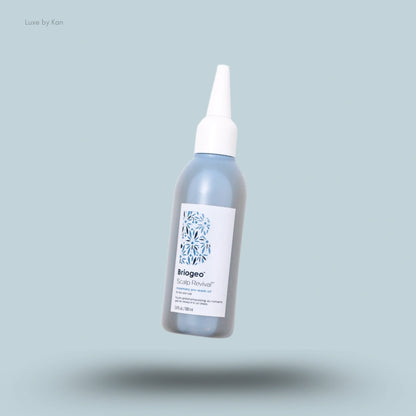 A bottle of Briogeo Scalp Revival™ Rosemary Pre-Wash Oil in a blue bottle with a white applicator cap.
