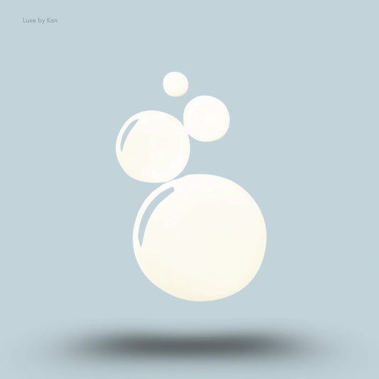 Three light yellow, creamy oil droplets, representing Briogeo Scalp Revival™ Rosemary Pre-Wash Scalp and Hair Oil.