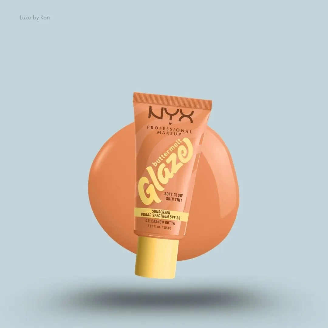 NYX Professional Makeup Buttermelt Glaze Skin Tint SPF 30 tube and swatch on blue background — LBK