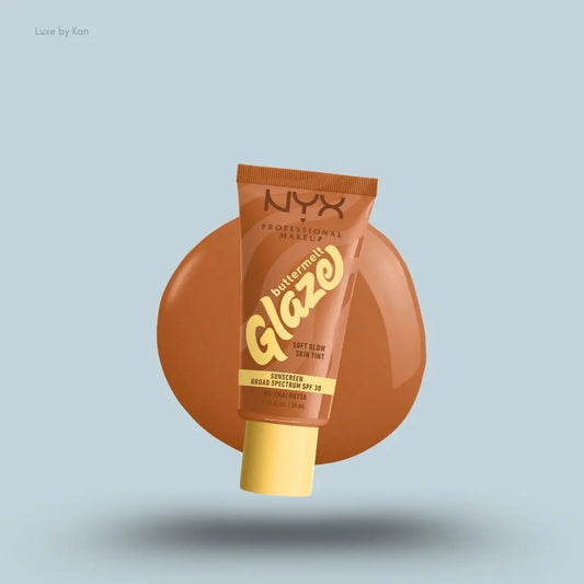 NYX Professional Makeup Buttermelt Glaze Skin Tint SPF 30 tube and swatch on blue background — LBK