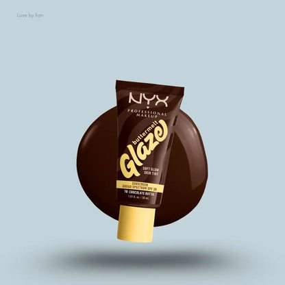 NYX Professional Makeup Buttermelt Glaze Skin Tint SPF 30 tube and swatch on blue background — LBK