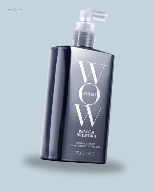 A sleek dark bottle of Color Wow Dream Coat for Curly Hair, labeled as a miracle moisture mist for frizz-free curls, 200 ml.