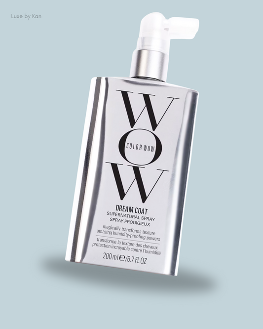 A sleek silver spray bottle labeled "Color Wow Dream Coat Supernatural Spray," designed to transform hair texture and resist humidity. 200ml/6.7 fl oz.