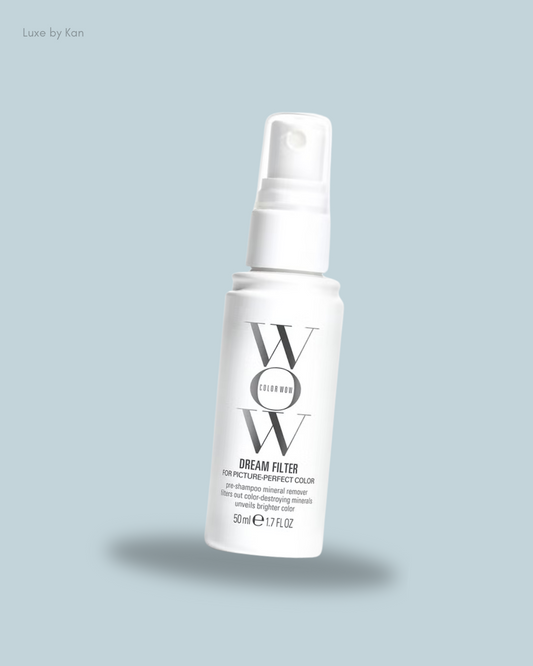A white spray bottle labeled "WOW Dream Filter", designed to enhance hair color between shampoos.
