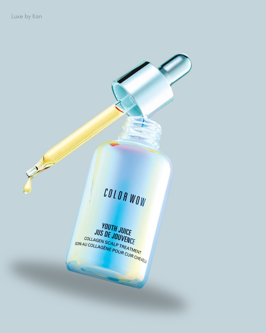 A dropper bottle of Color Wow Youth Juice collagen scalp treatment, with a golden serum dripping from the pipette.