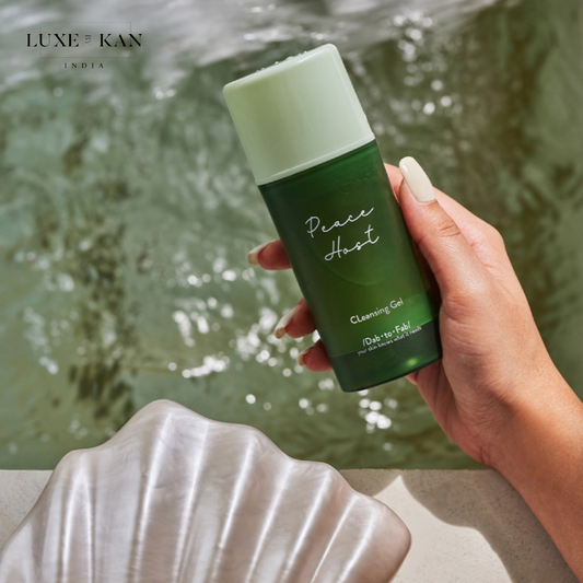 A hand holds DAB TO FAB Peace Host Cleanser product.