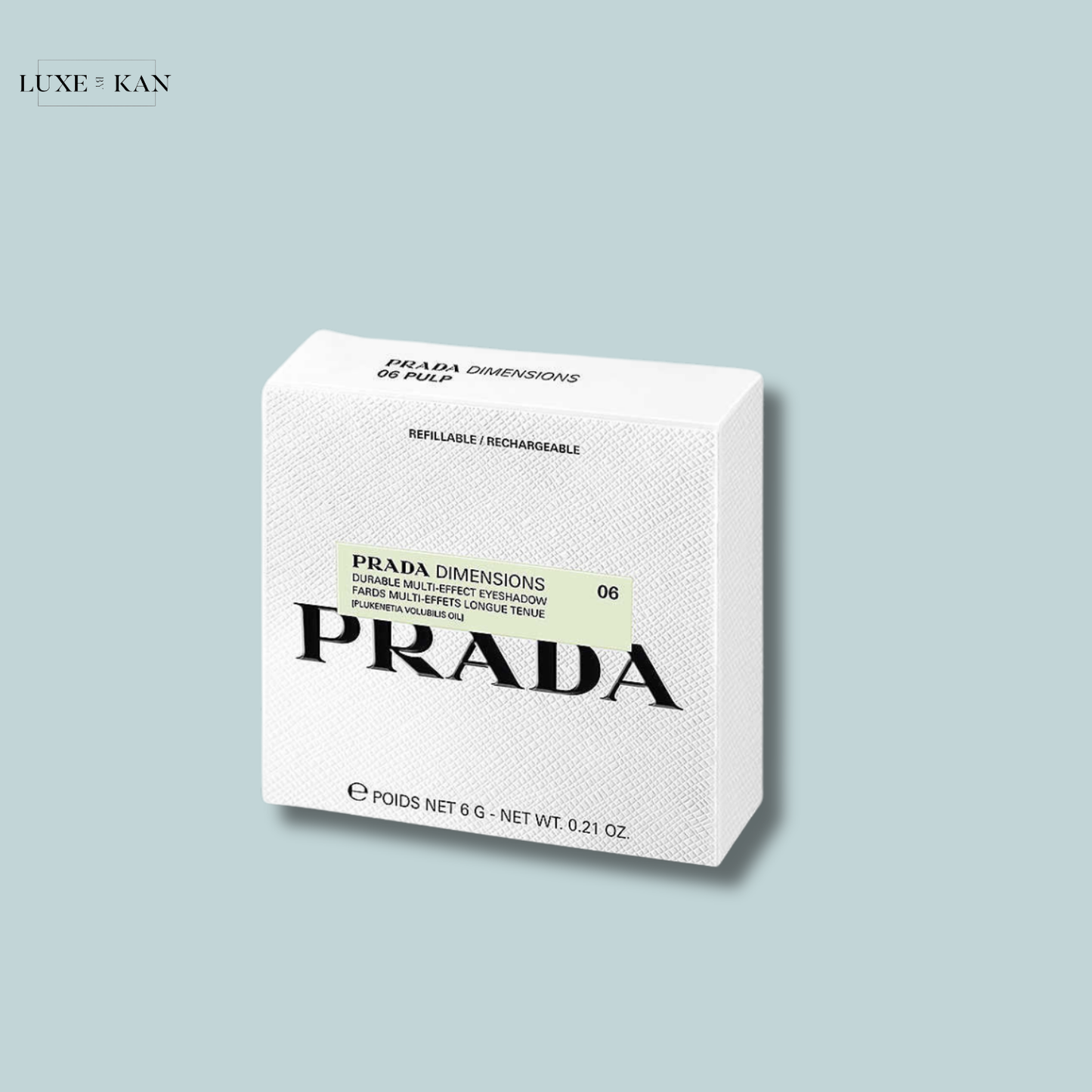 A stylish white box of Prada Dimensions eyeshadow labeled "06 Pulp," showcasing the refillable and rechargeable design.