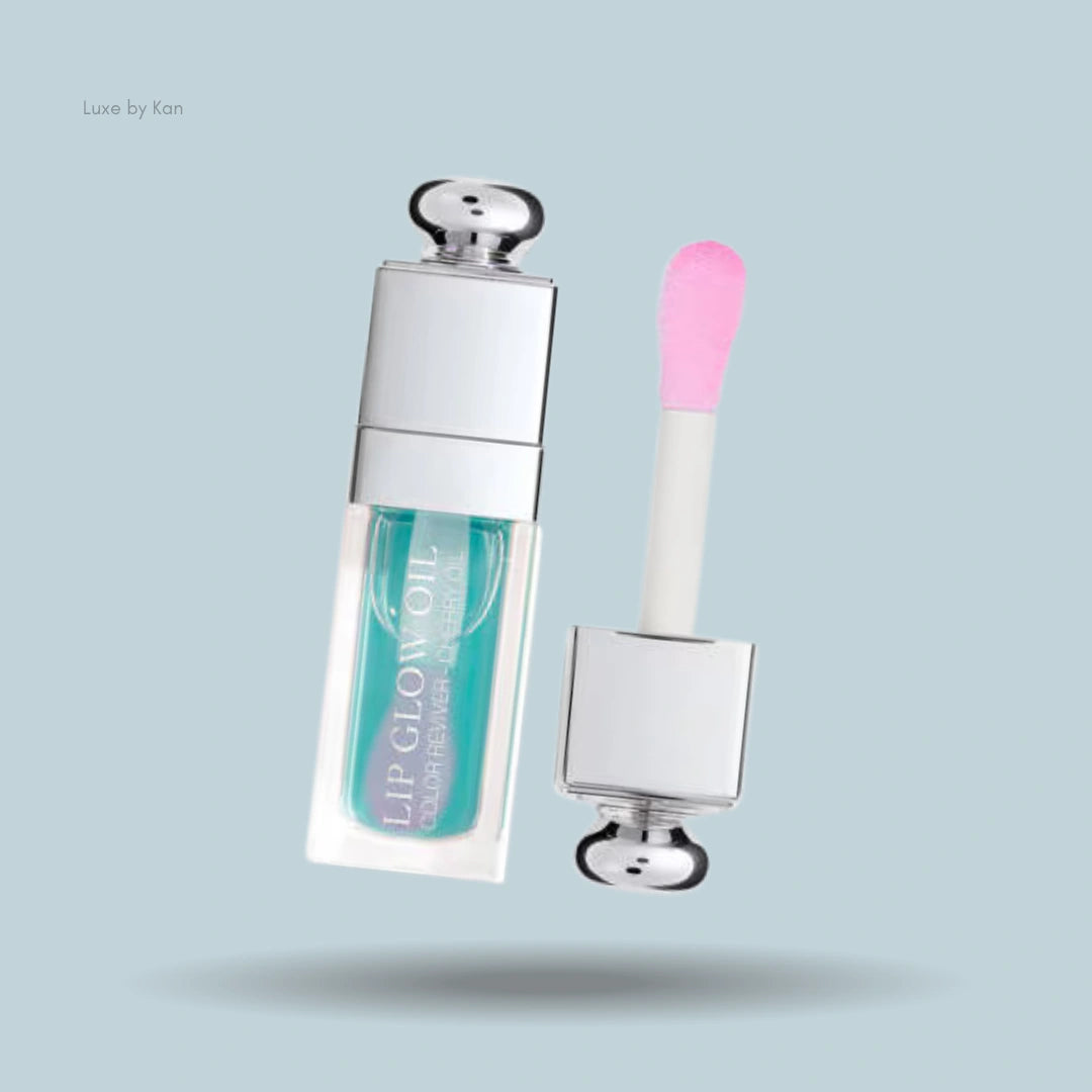 Dior Addict Lip Glow Oil featuring a vibrant turquoise tint, housed in a sleek clear tube with a soft pink applicator for smooth, glossy application.