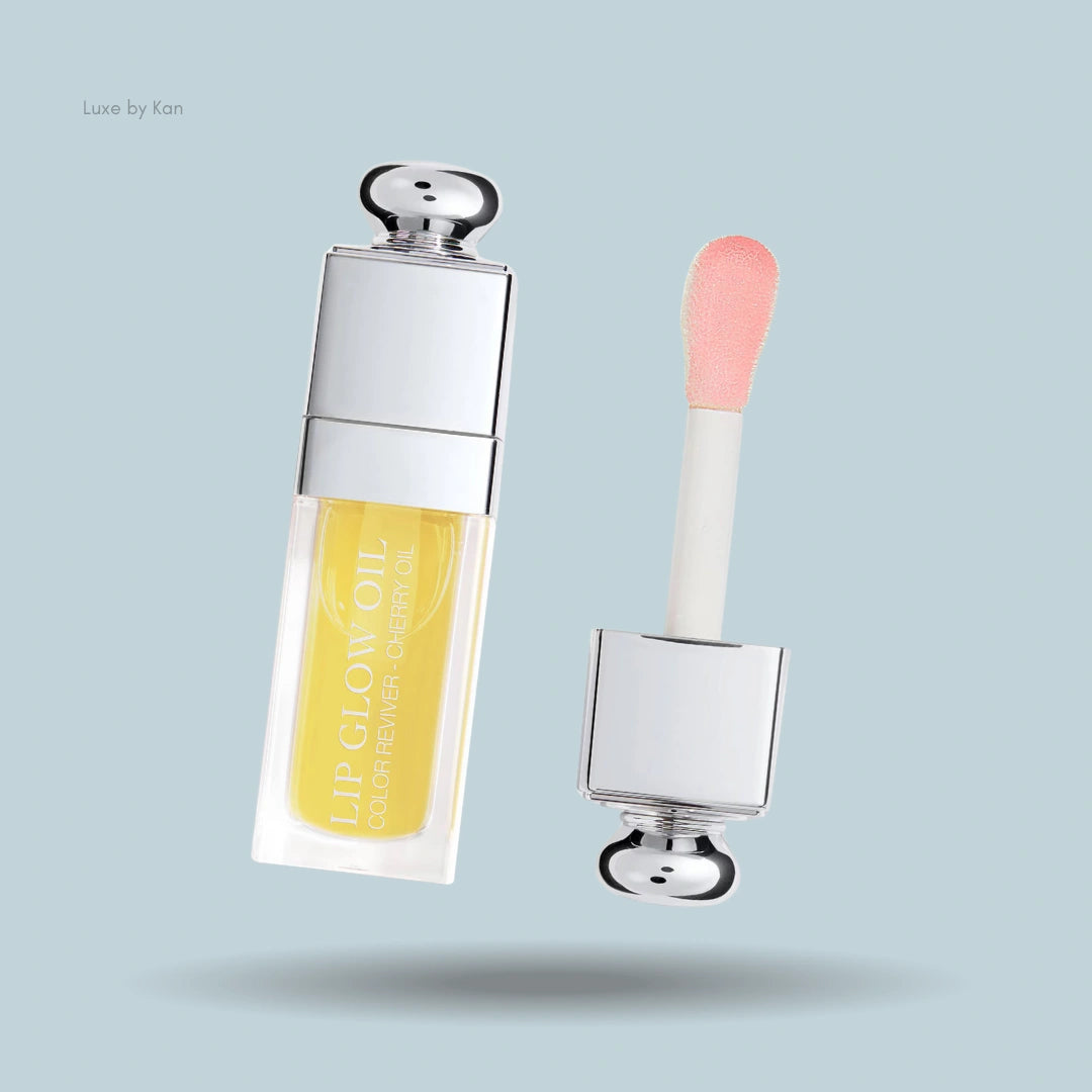 Dior Lip Glow Oil featuring a nourishing yellow-tinted formula, shown with its soft pink-tinged applicator.