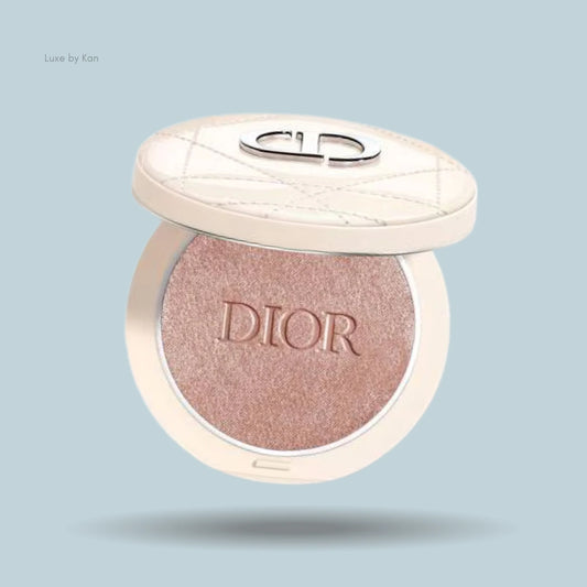 Dior Forever Couture Luminizer highlighting powder in a round, ivory compact, partially open, with a silver Dior logo on the lid.