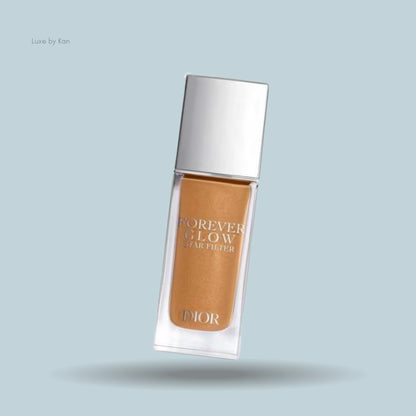 A bottle of Dior Forever Glow Star Filter foundation, shown in a warm golden shade with a radiant finish.