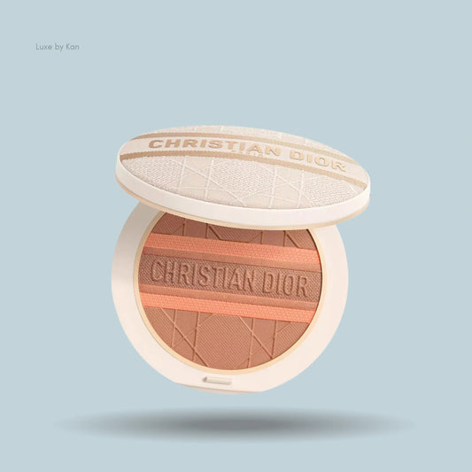 Dior Forever Natural Bronze Glow bronzer with open lid, revealing stripes of deep brown and sandy apricot powder embossed with "CHRISTIAN DIOR".