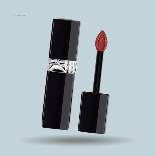 Dior Rouge Dior Forever Lacquer lipstick, featuring a glossy black tube with a silver Cannage band, and an applicator brush with red lacquer.