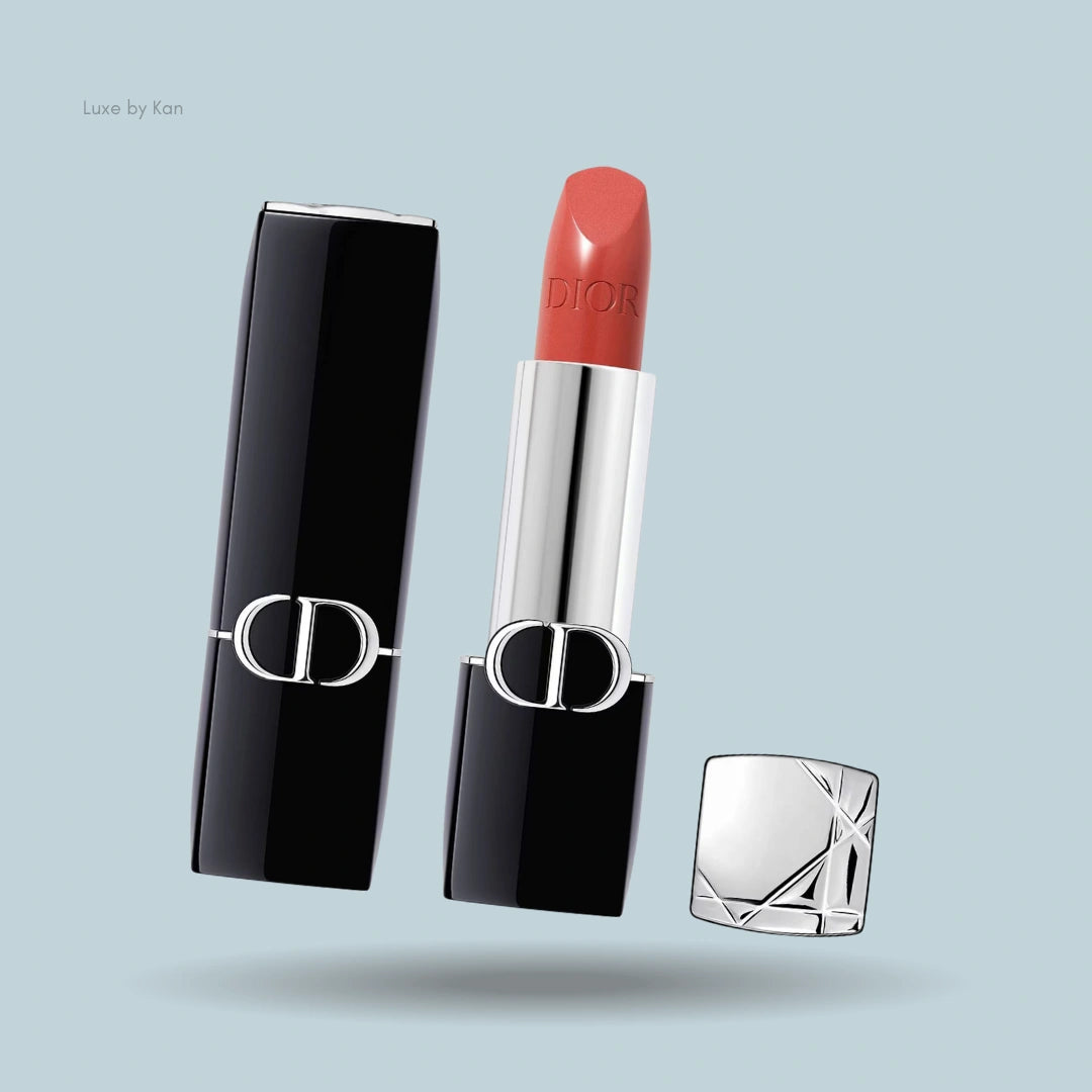 Dior Rouge Lipstick housed in an elegant black case, showcasing a rich red velvet texture with the cap stylishly offset for a sleek, modern display.

