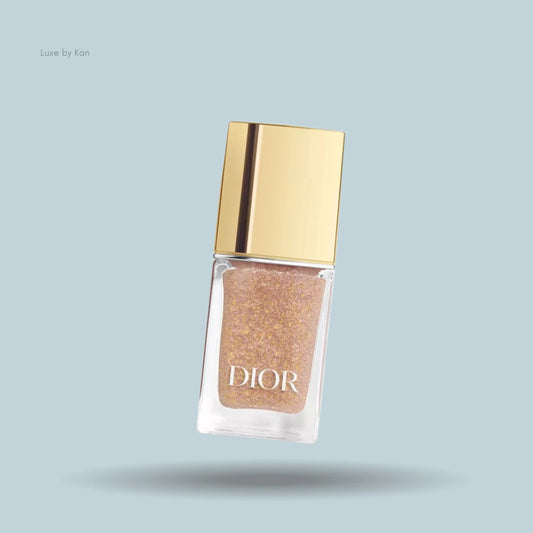 Dior Vernis Top Coat nail polish bottle, filled with glitter polish and golden cap.