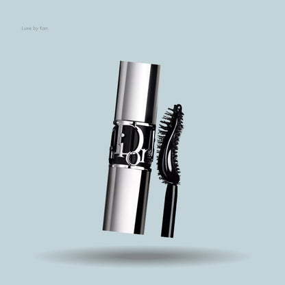Close-up of Diorshow volume and curl mascara, showing the silver tube with Dior logo and curved wand.