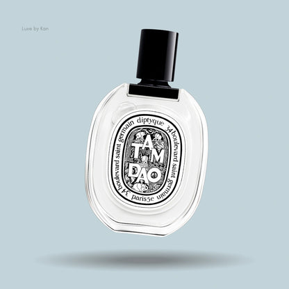 Diptyque Tam Dao Eau de Toilette in an oval-shaped transparent bottle with a black cap and signature black label.