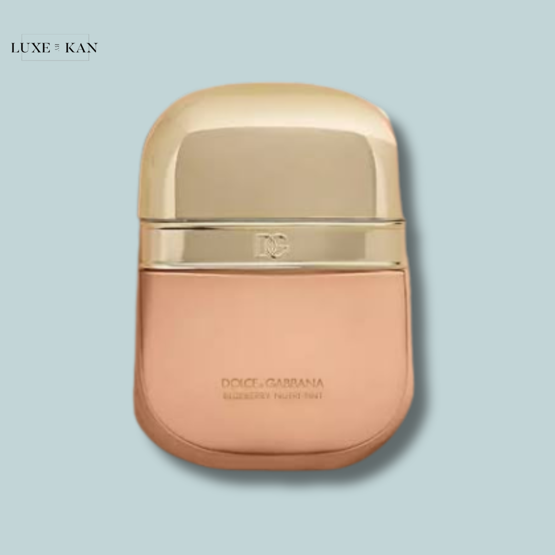 Gold and rose-colored Dolce & Gabbana makeup compact featuring a sleek, elegant design.