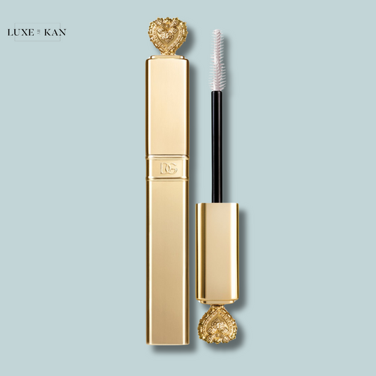 A luxurious dolce&gabbana devotion extreme volume mascara tube with a heart-shaped cap, accompanied by a sleek applicator wand.