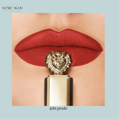 Close-up of bold red lips with a luxurious golden lipstick adorned with a lion heart design, labeled "400 pride."