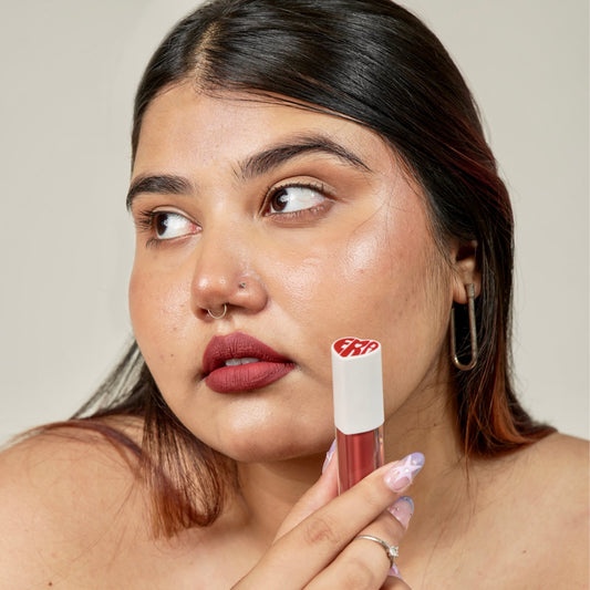A woman face close-up with era beauty velvet liquid matte lipstick in shade rom-com.