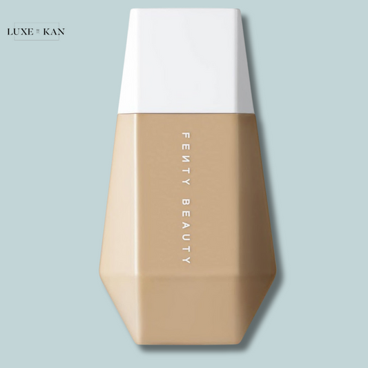 Fenty Beauty Eaze Drop Blurring Skin Tint in a geometric bottle with a white cap, the brand name presented vertically.