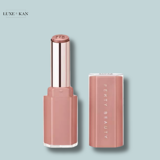 Fenty Beauty Gloss Bomb Stix Lip Gloss with its lid removed, revealing a mauve-colored balm.