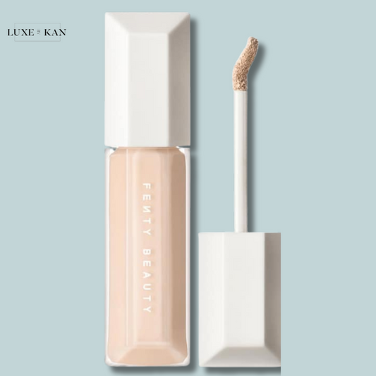 Fenty Beauty We’re Even Hydrating Longwear Concealer in a sleek clear tube with a white lid, featuring a soft applicator wand beside it.