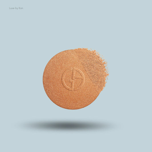Giorgio Armani Luminous Silk Glow Highlighter with a logo, partially revealing its soft powder.