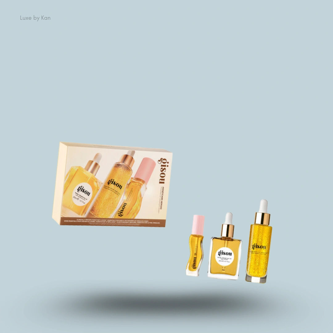 A box of Gisou Honeycare Heroes set with three miniature bottles of shimmering hair oil and perfume.