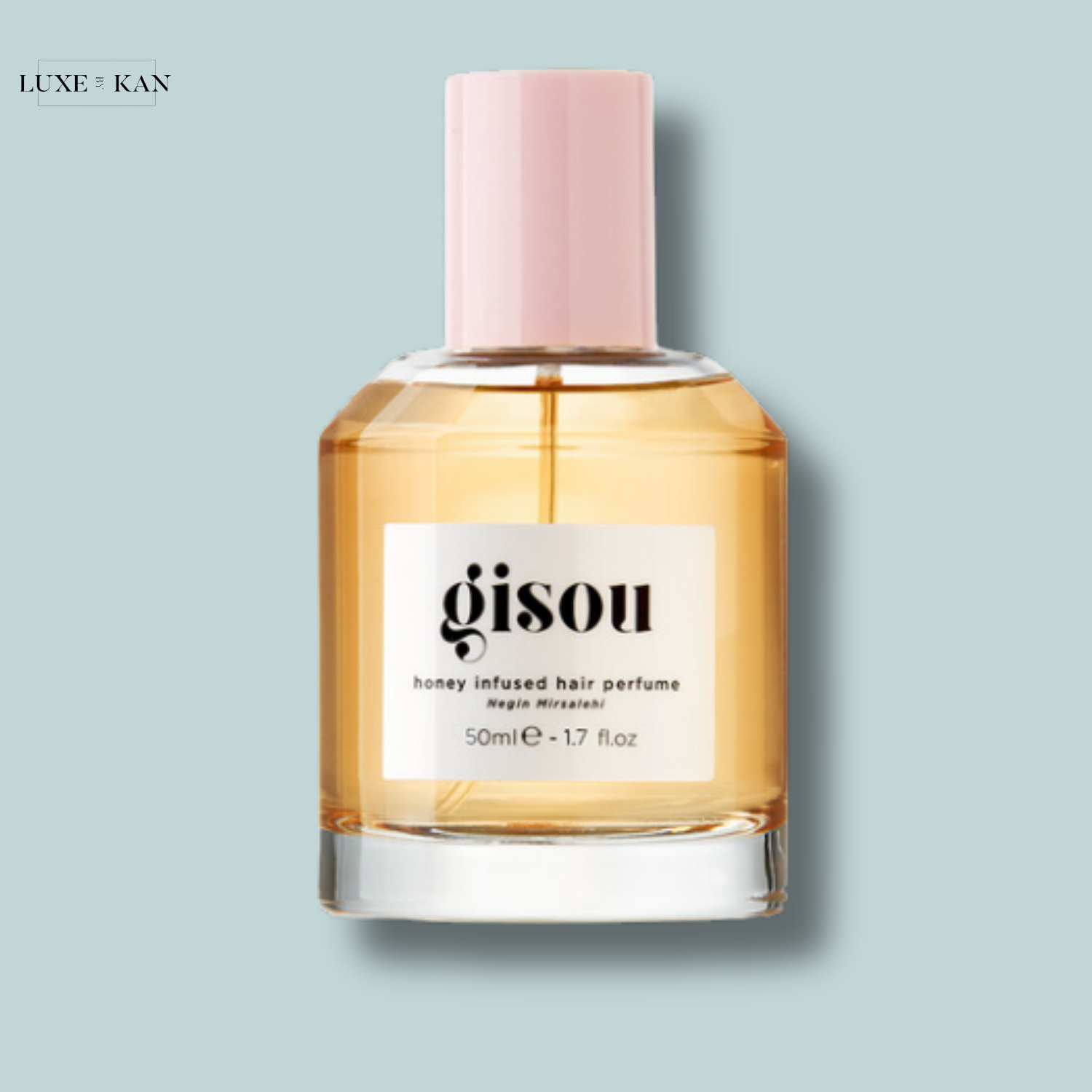 Gisou honey-infused hair perfume in a sleek bottle with a pink cap, offering a 50ml fragrance for lush, scented hair.