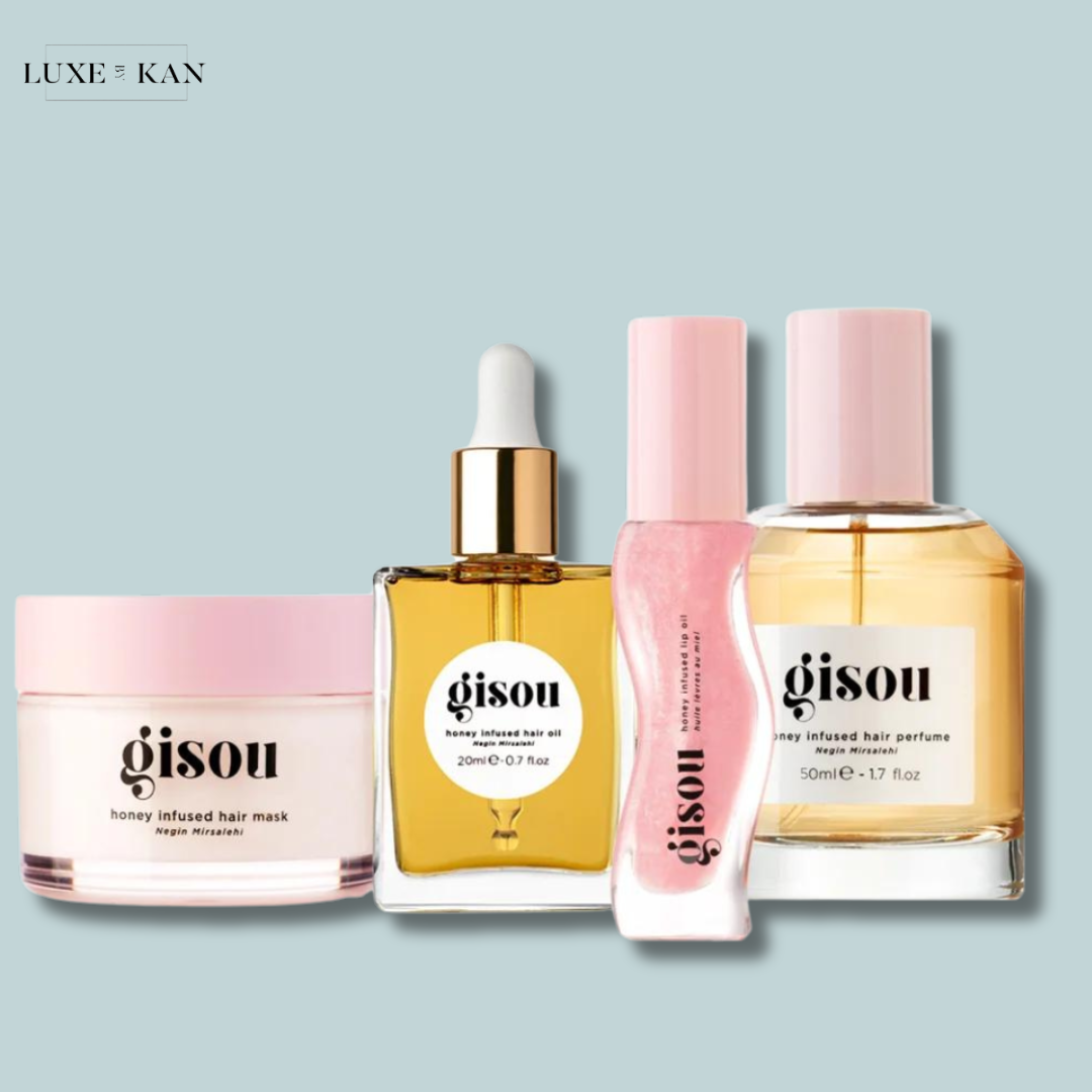 Four Gisou hair products, including a honey-infused mask, oil, serum, and perfume.