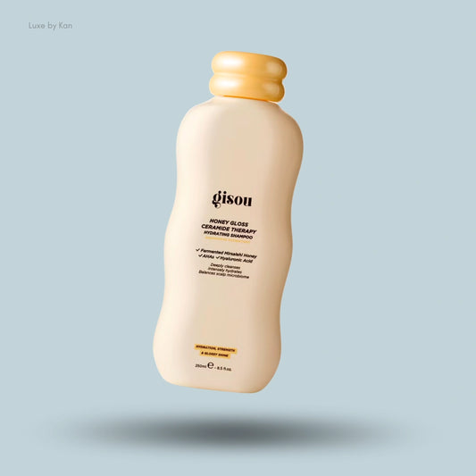 Gisou Honey Gloss Ceramide Therapy Shampoo bottle with yellow cap, highlighting its hydrating properties.